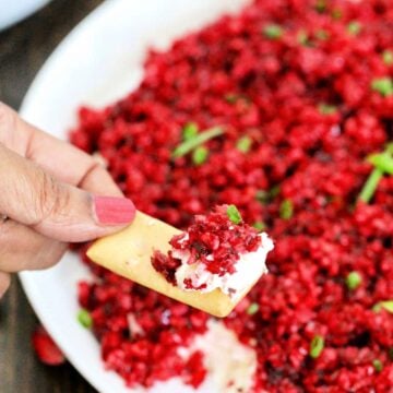 Scoop of cranberry jalapeno dip on a cracker