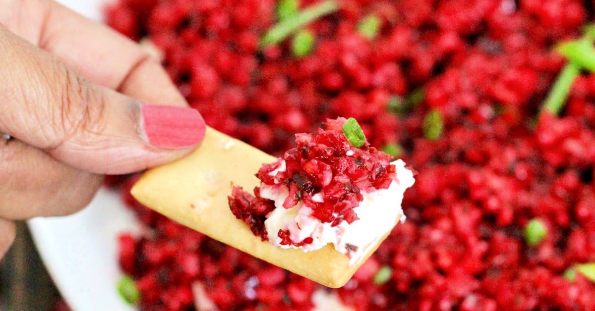 Scoop of cranberry jalapeno dip on a cracker