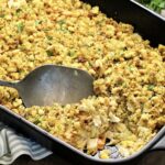 Turkey and Stuffing Casserole in a black baking dish with a scoop taken out.