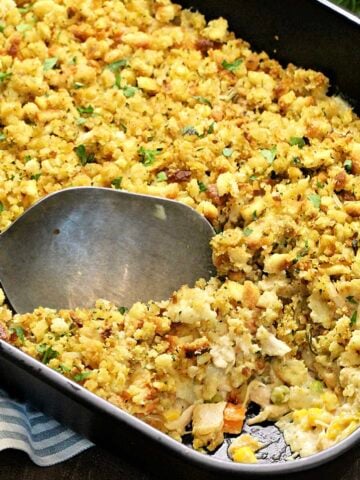 Turkey and Stuffing Casserole in a black baking dish with a scoop taken out.