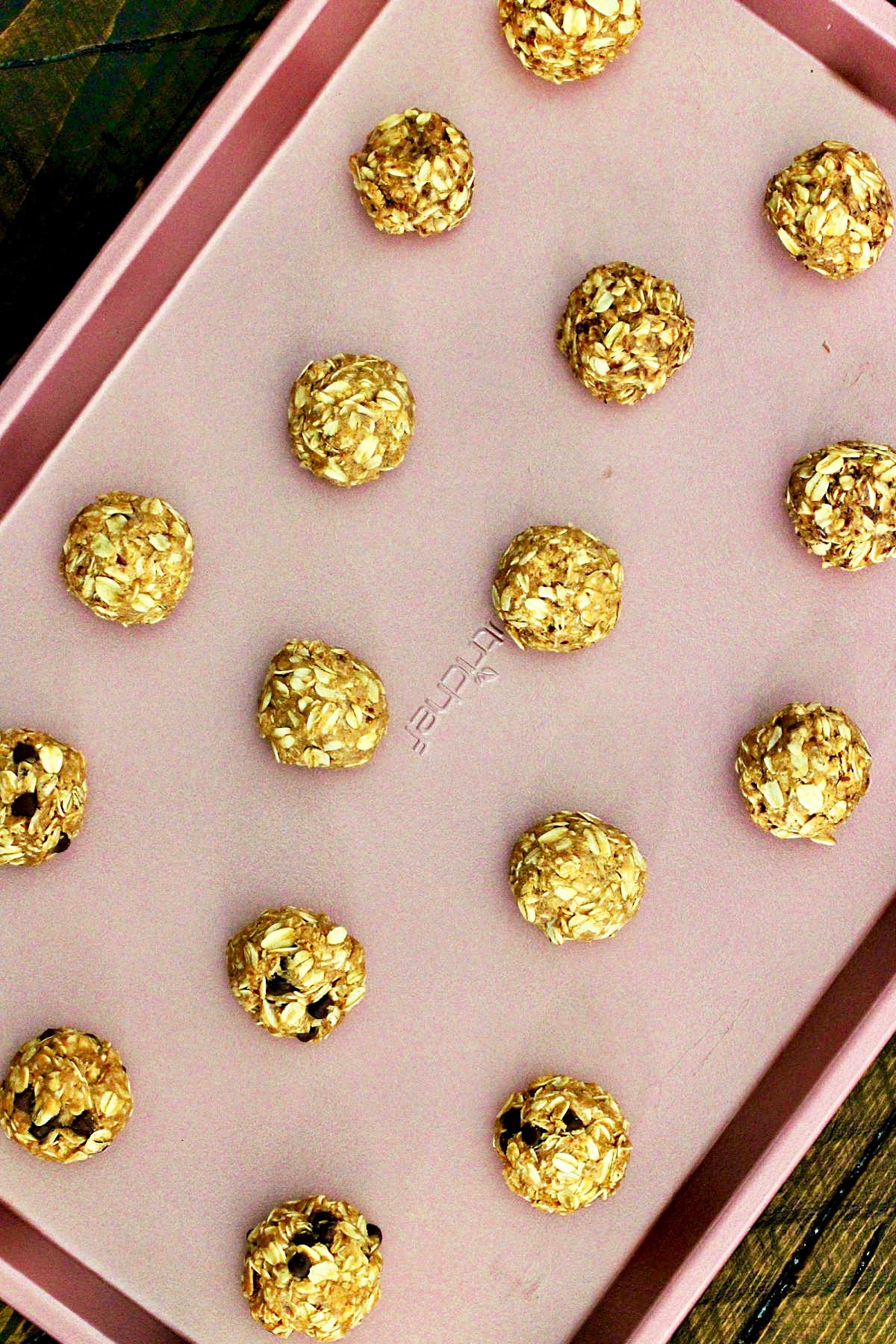 Oatmeal Energy Balls on a pink baking sheet.