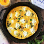 Ricotta, spinach and mushroom frittata in a cast iron skillet.