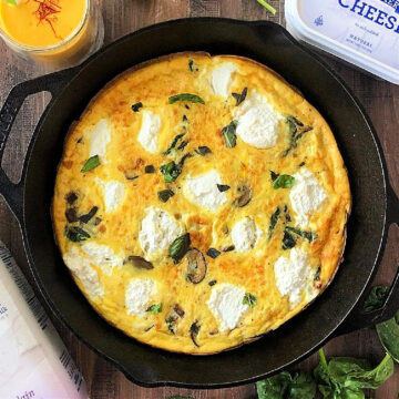 Ricotta, spinach and mushroom frittata in a cast iron skillet.