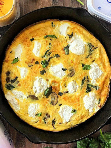 Ricotta, spinach and mushroom frittata in a cast iron skillet.