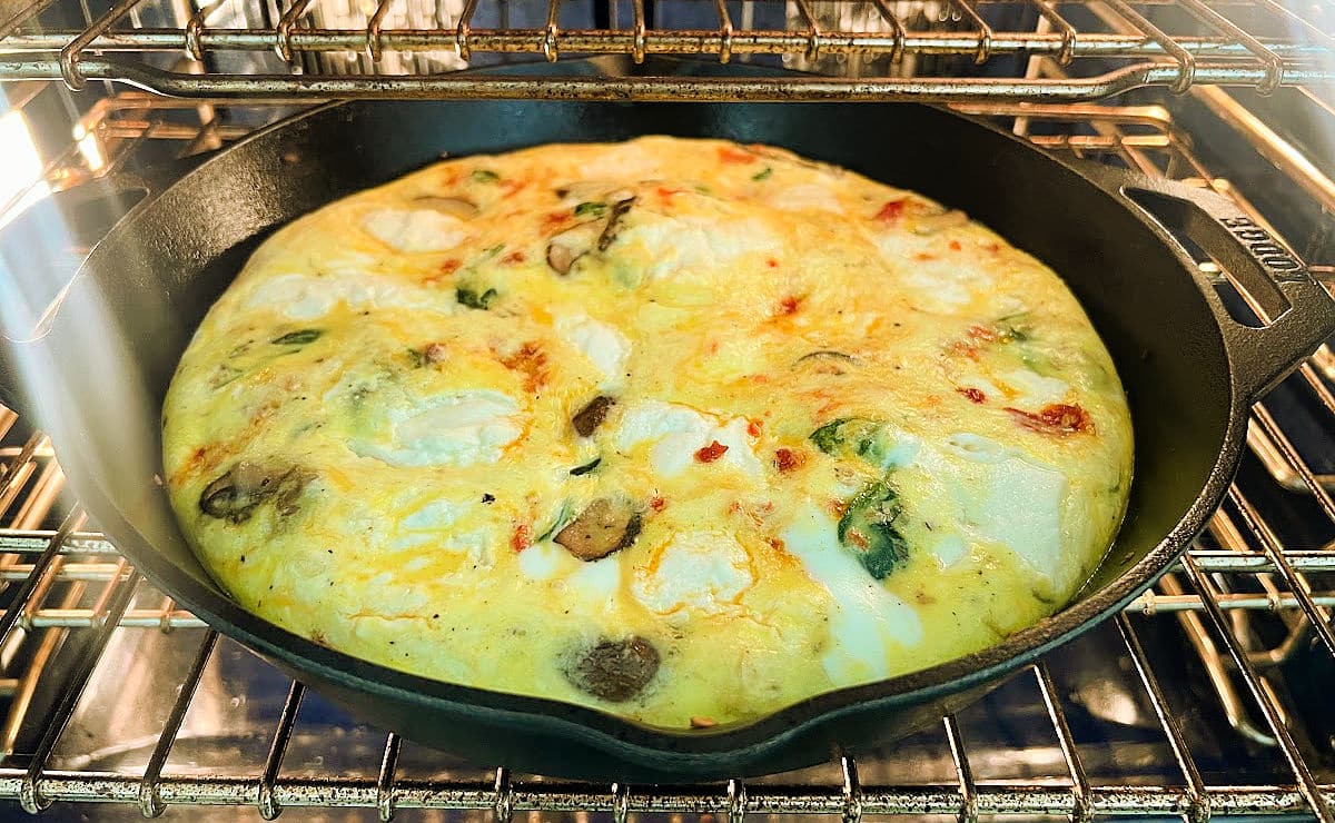 Ricotta frittata baking in an oven.