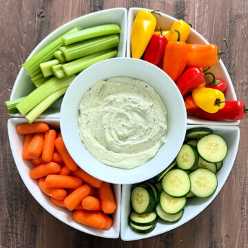 3-Ingredient Cottage Cheese Dip in a serving platter surrounded by fresh veggies.