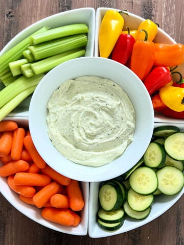 3-Ingredient Cottage Cheese Dip in a serving platter surrounded by fresh veggies.