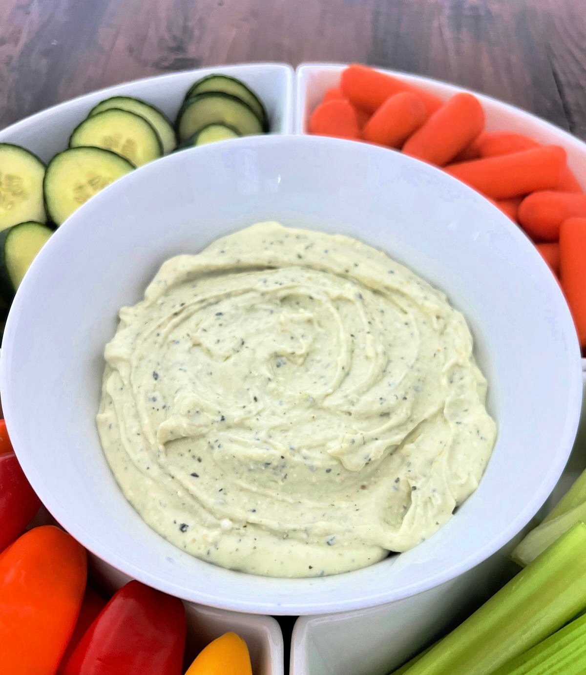 3-Ingredient Cottage Cheese Dip in a serving platter surrounded by fresh veggies.
