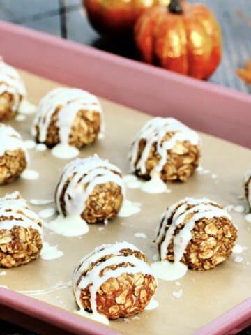Pumpkin protein balls on a sheet pan.