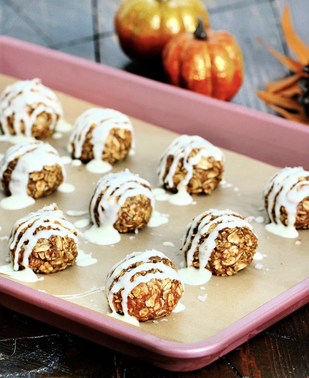 Pumpkin protein balls on a sheet pan.