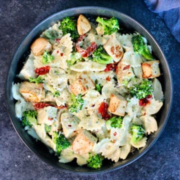 Pasta with Chicken and Creamy Cottage Cheese Sauce in a black bowl on a slate board.