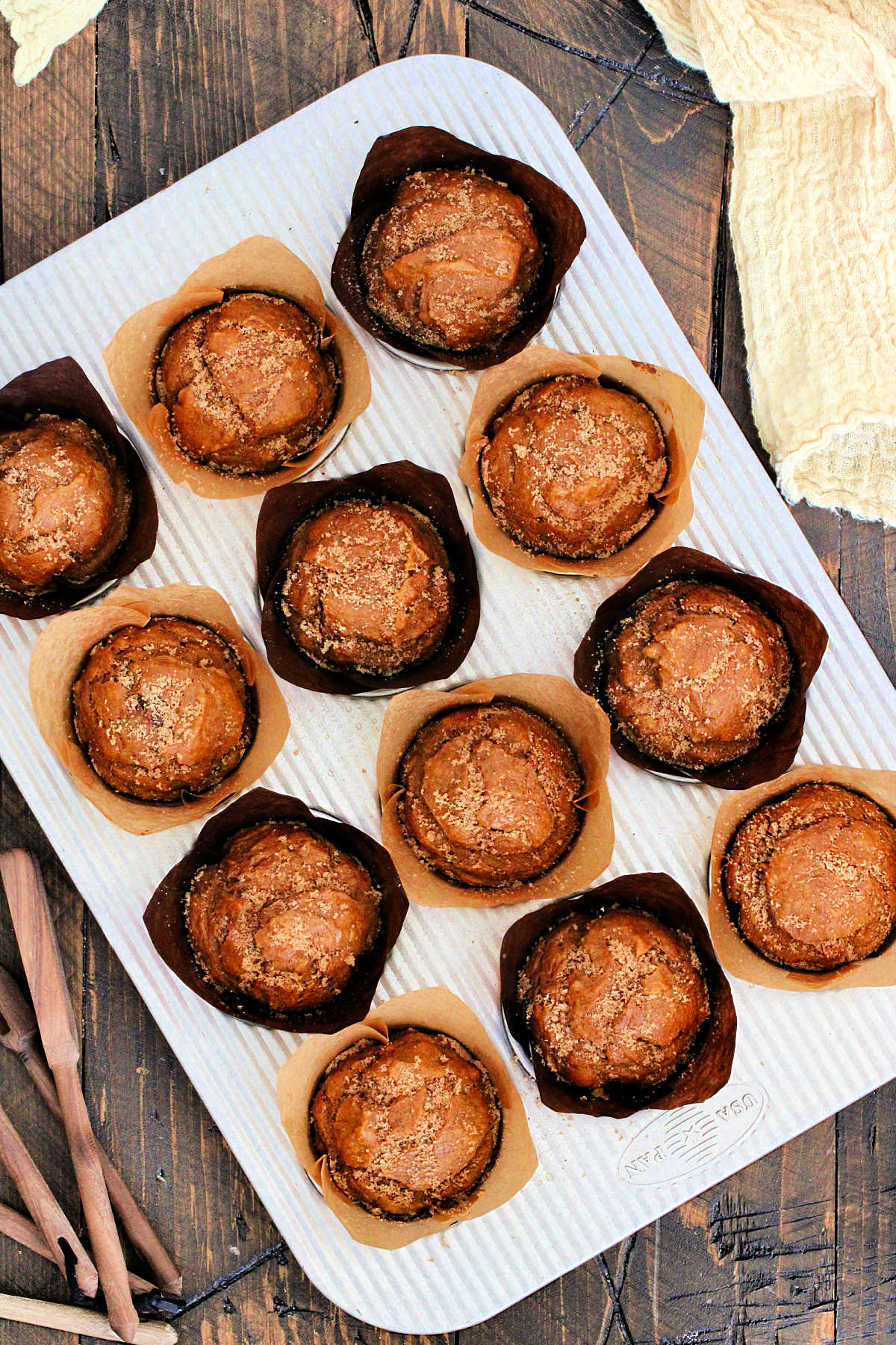 Easy Pumpkin Banana Muffins in a muffin pain on a wooden board.